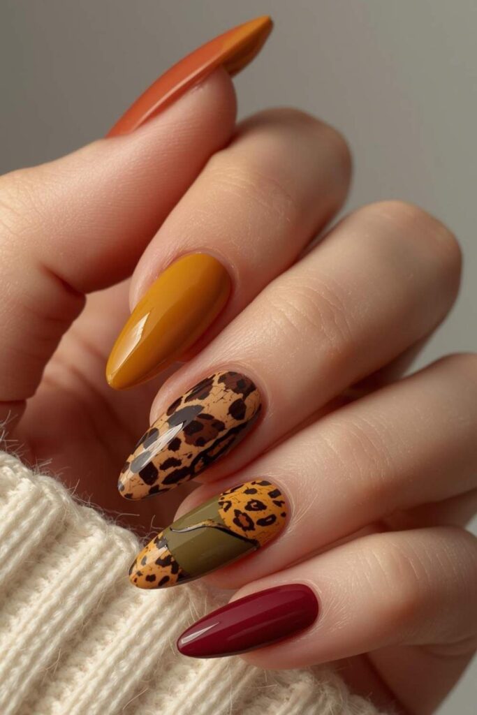 Autumn acrylic nails featuring burgundy, mustard, olive green, and tortoiseshell nail art.