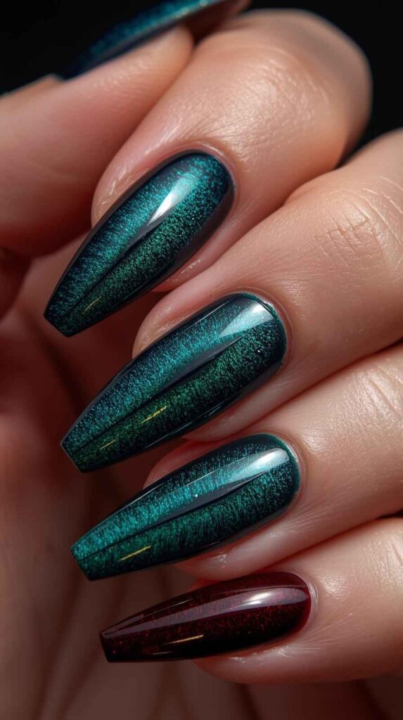 Magnetic cat eye acrylic nails with reflective shimmer effect in deep jewel tones.