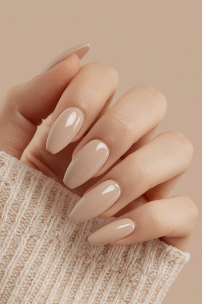 Neutral glossy acrylic nails with minimalist luxury manicure styling and refined salon finish.