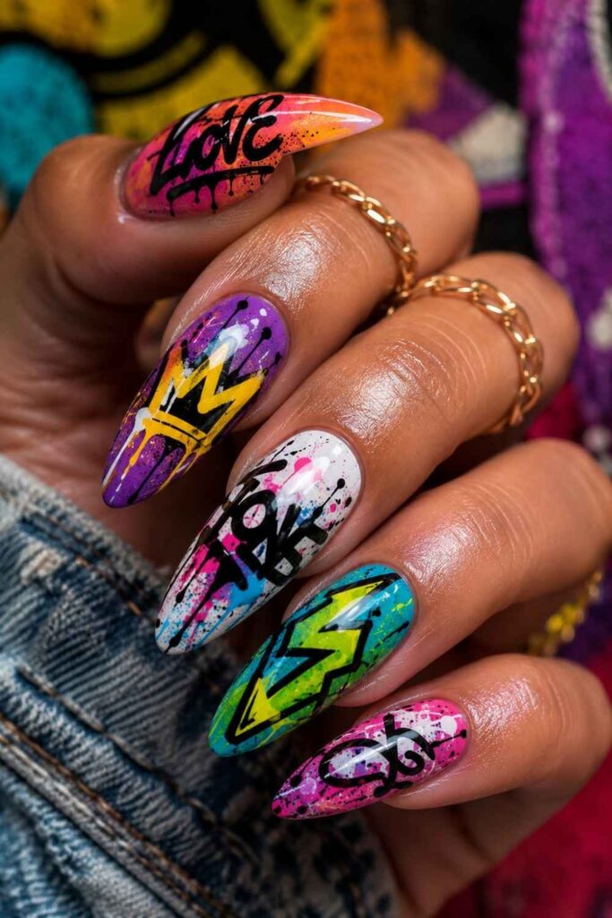 Graffiti-inspired acrylic nails with colorful street art details, bold graphics, and glossy modern nail art.