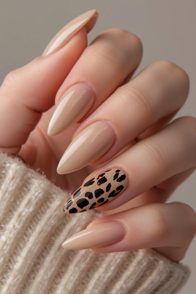 Nude acrylic nails decorated with stylish leopard print nail art and glossy salon-quality detailing.