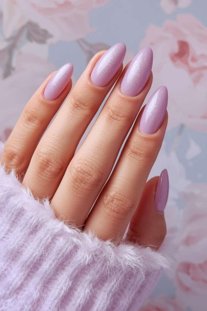 Glossy lilac acrylic nails with soft pastel shimmer on elegant almond-shaped nails.