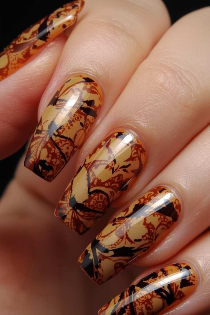 Glossy mocha tortoiseshell coffin acrylic nails featuring caramel and amber marbled patterns inspired by luxury beauty trends.