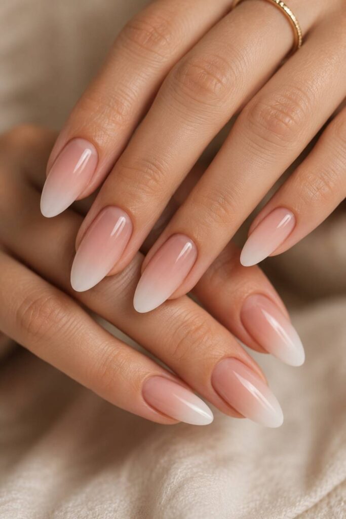 Nude-to-white ombre acrylic nails with a seamless gradient and glossy salon-quality finish.