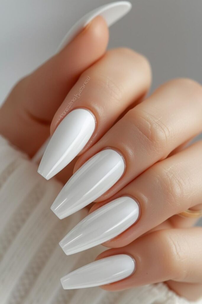 Glossy porcelain-inspired white acrylic nails with translucent luxury manicure and glass-like shine.