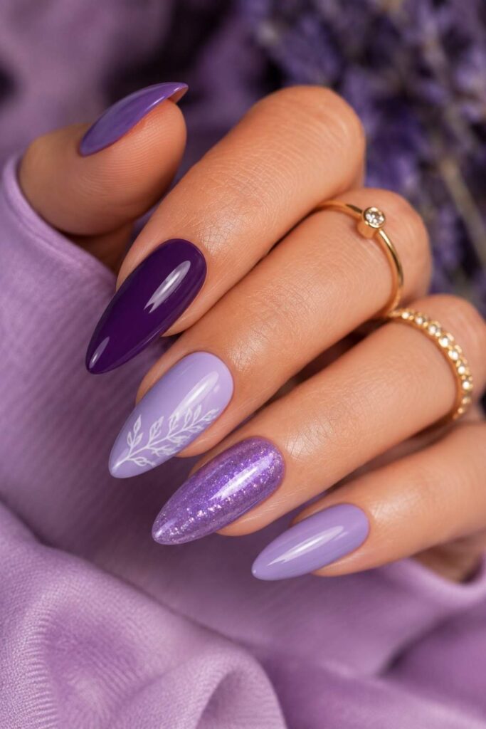 Glossy purple acrylic nails featuring lavender, violet, and plum shades with luxury manicure styling.