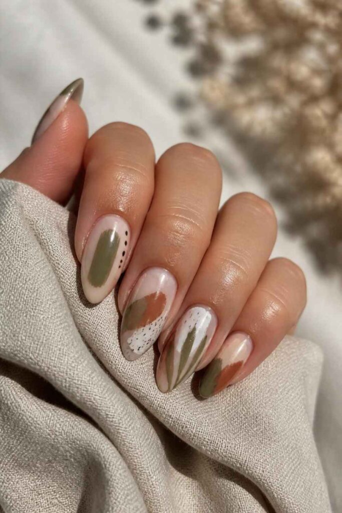 Abstract long acrylic nail inspo with terracotta, cream, and olive nail art.