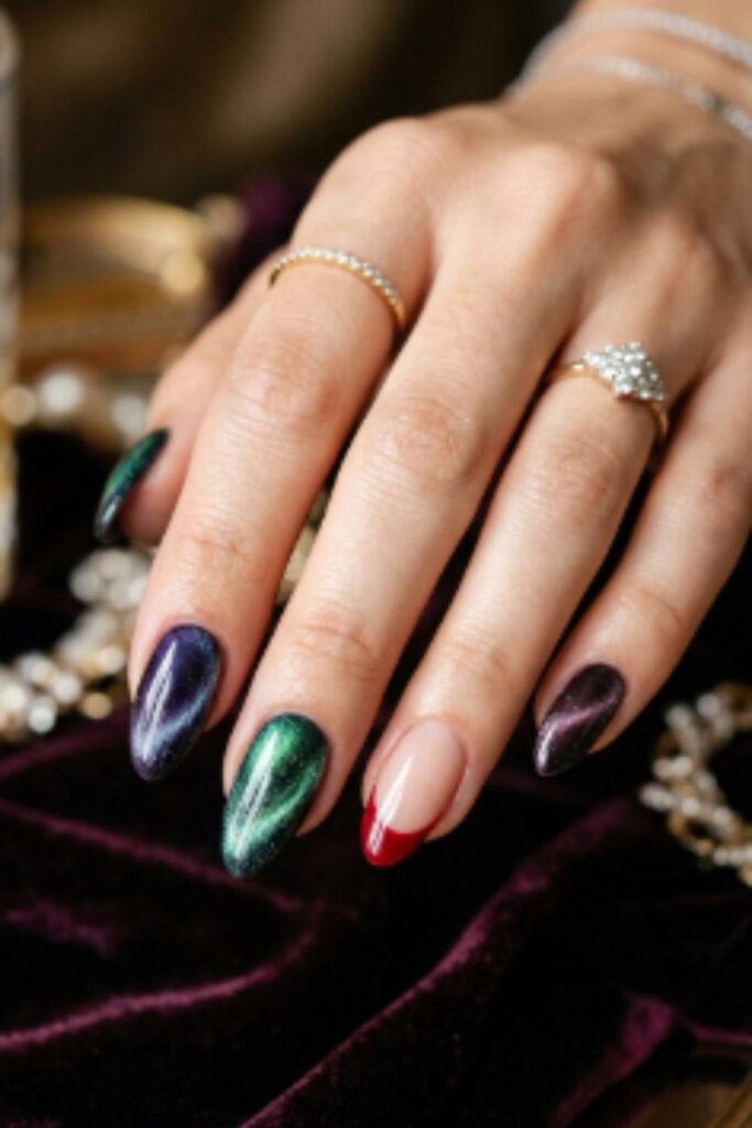 Magnetic cat-eye nails with shifting emerald, sapphire, and plum reflections alongside elegant Red French Tip Nails.