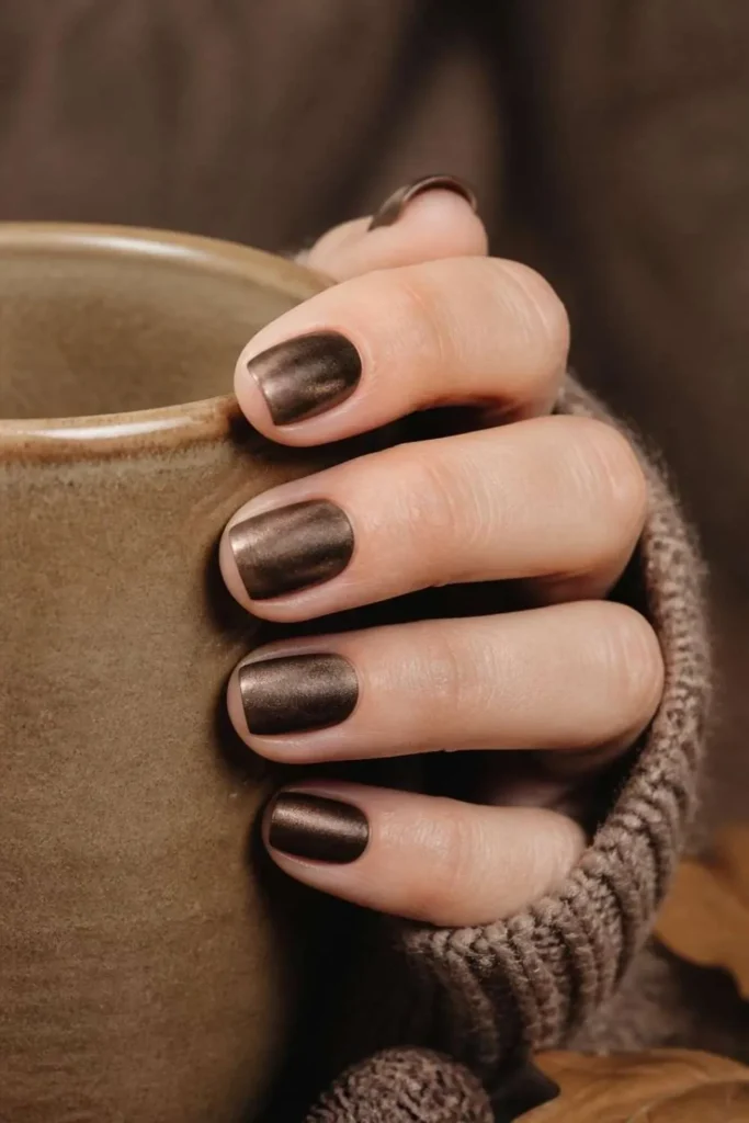 Short squoval nails with rich chocolate brown velvet polish and a soft magnetic suede effect.