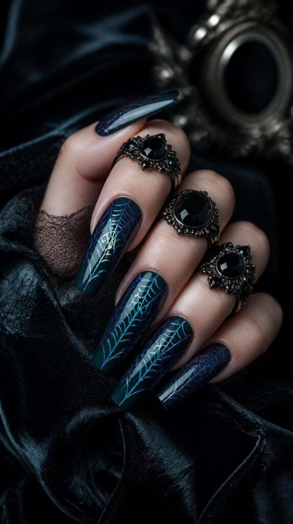 Dark teal gothic acrylic nail designs featuring holographic spider web overlays on glossy coffin nails.