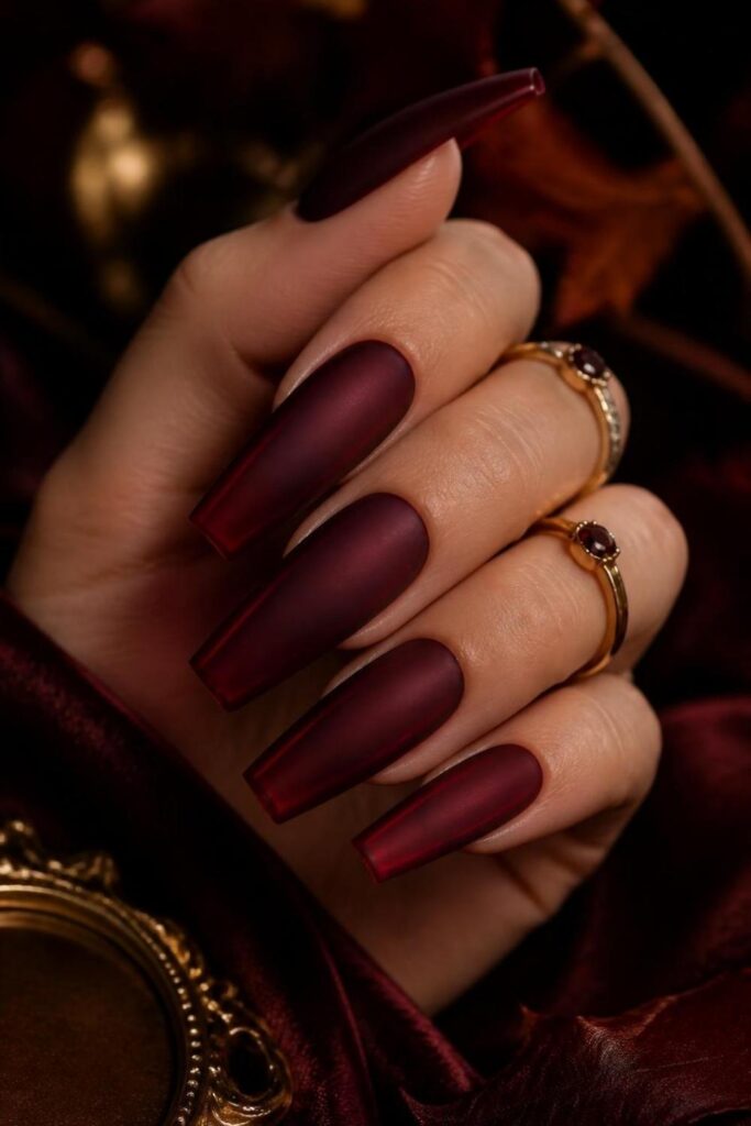 Deep burgundy jelly acrylic nails with a soft matte finish that enhances the translucent wine-colored depth.