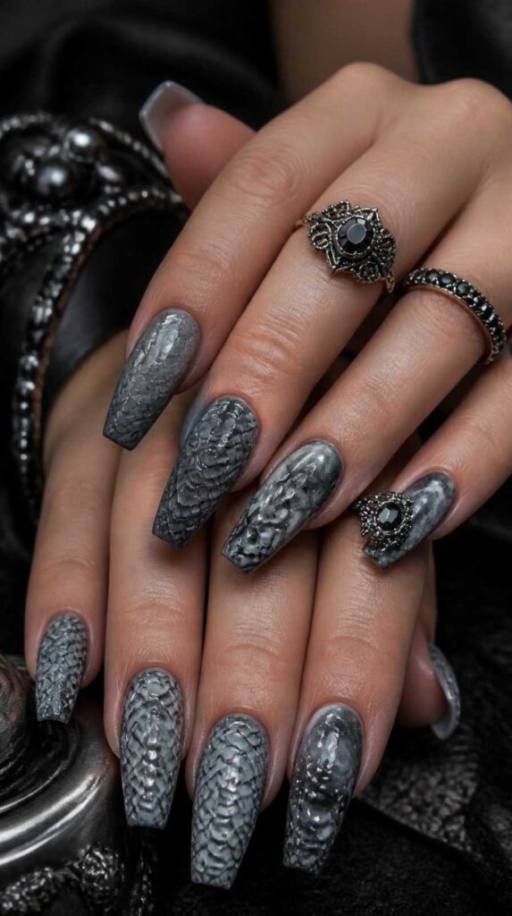 Monochrome gray gothic acrylic nail designs with raised snake texture on coffin nails.