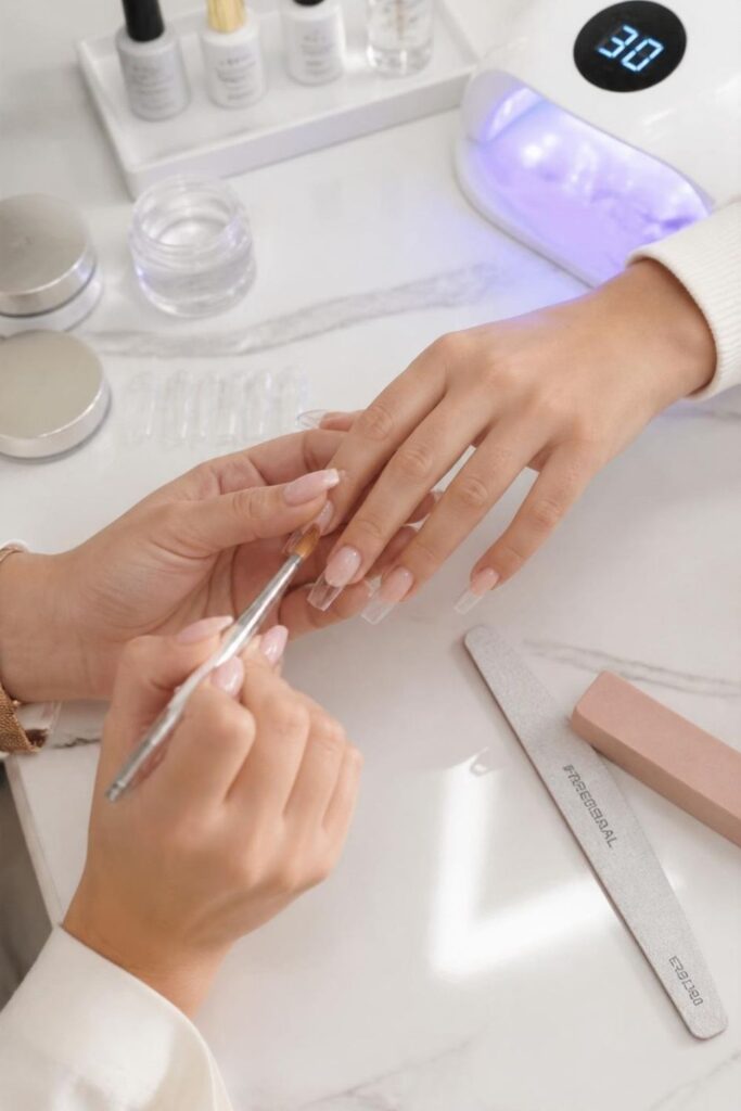 DIY hard gel nail extension kit featuring natural nail tips, professional nail files, and glossy reinforced gel extensions.
