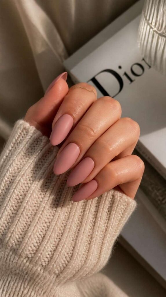 Long matte almond pink acrylic nails with a soft dusty rose finish and elegant minimalist style.