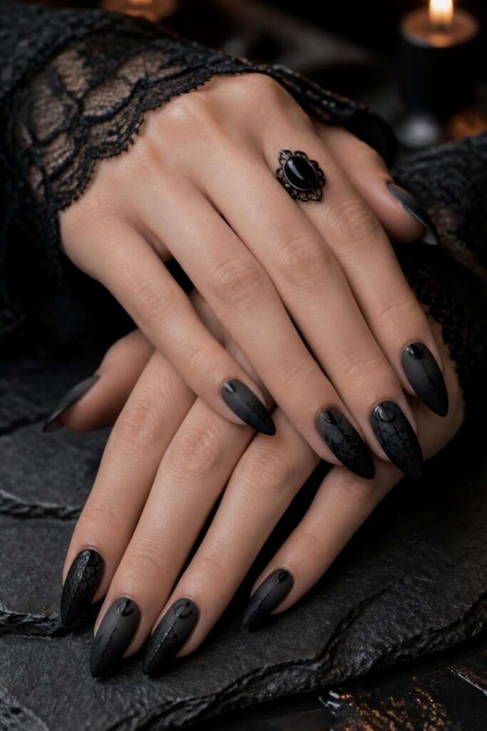 Matte black almond gothic acrylic nail designs with subtle smoky ombre gradient and soft luxury finish.