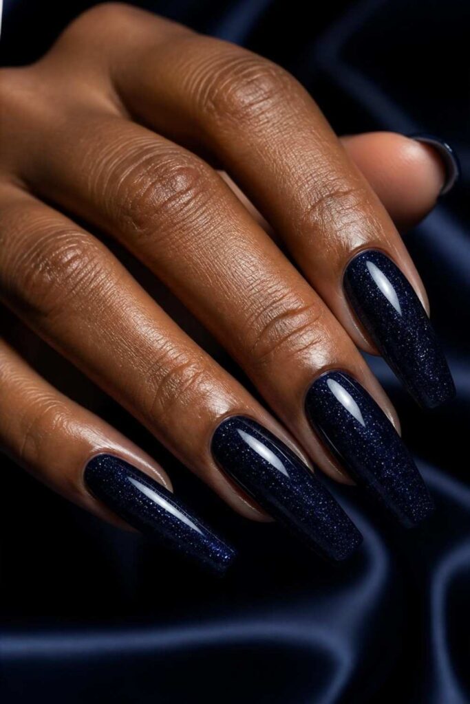 Midnight navy long acrylic nail inspo with subtle micro glitter and glossy coffin nails