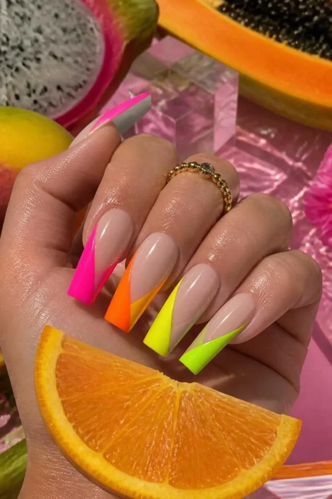 Bright neon gel nails with modern negative space geometric nail art.