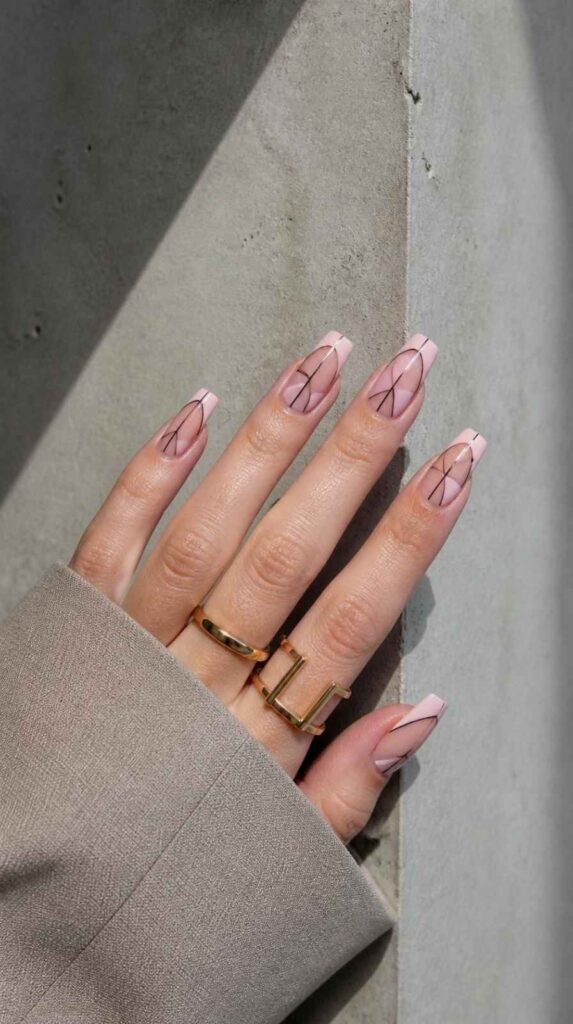 Minimalist pink acrylic nails with modern negative space geometric line nail art.