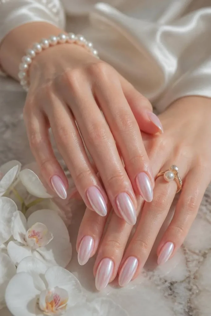 Pearly pink gel manicure with soft chrome shimmer and elegant glossy finish.