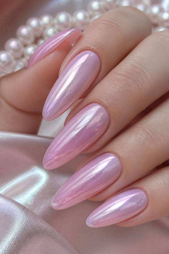 Rose quartz pink acrylic nails with a satin chrome finish creating a luminous gemstone-inspired manicure.