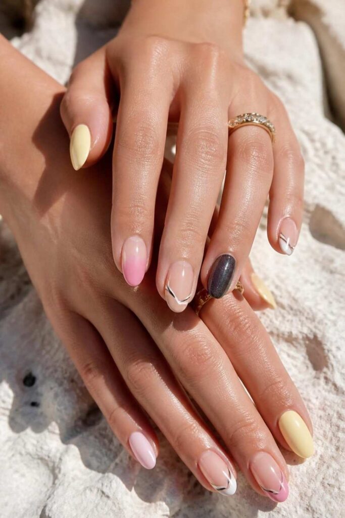 Stylish short almond nails featuring butter yellow polish, pink ombré, striped French tips, and shimmer black manicure ideas.