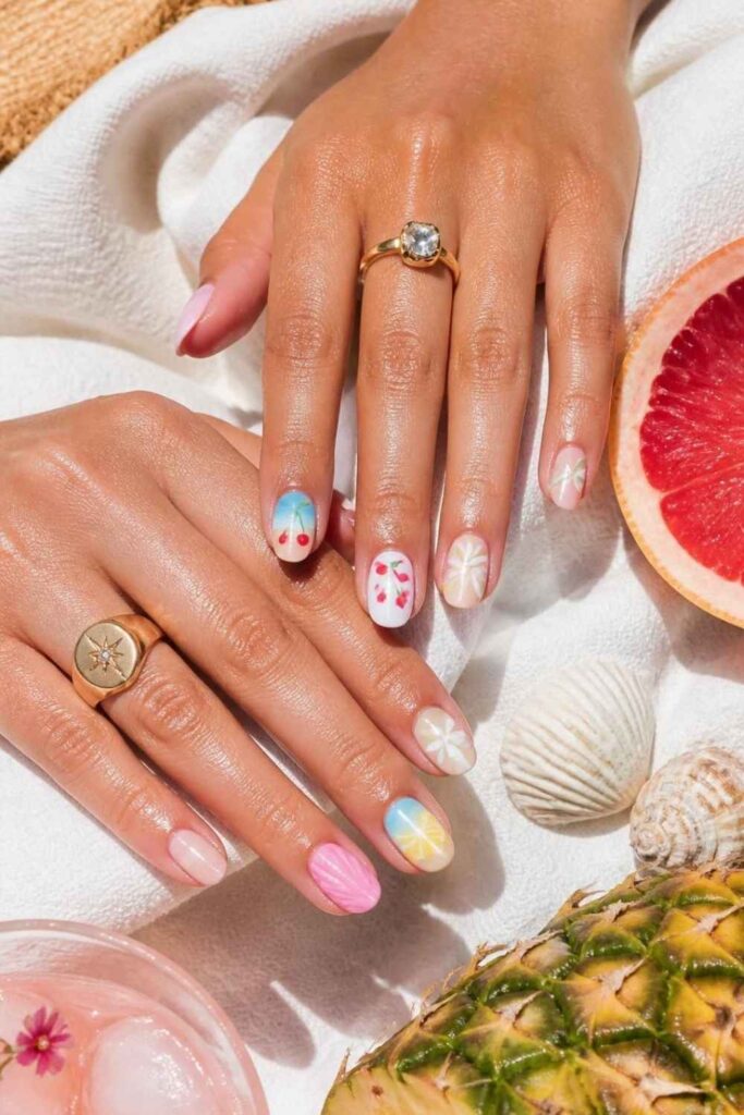 Colorful Short Nail Designs featuring tropical fruit nail art, seashell textures, pastel florals, and beach-inspired summer manicures.