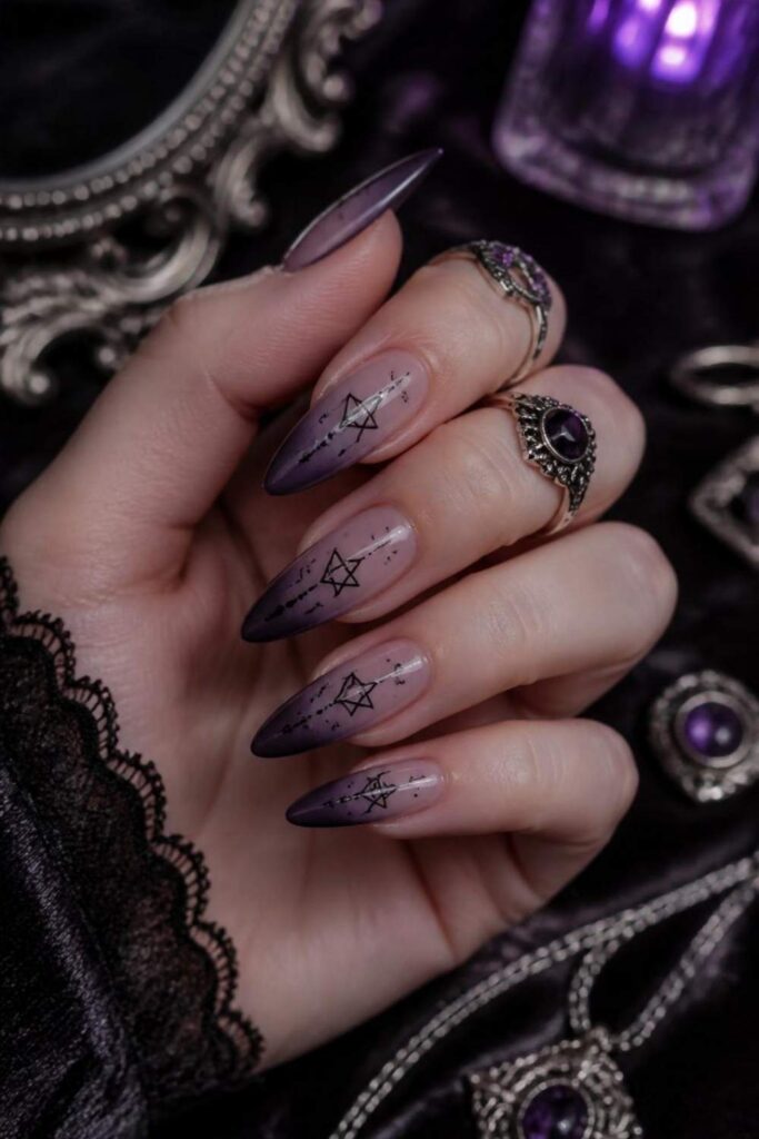 Smoky lavender gothic acrylic nail designs with black pentagram accents on almond nails.