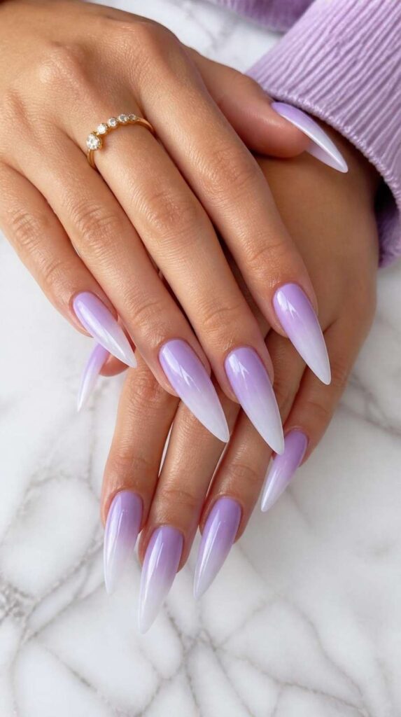 Soft lavender stiletto long acrylic nail inspo with frosted ombré tips and glossy salon finish.