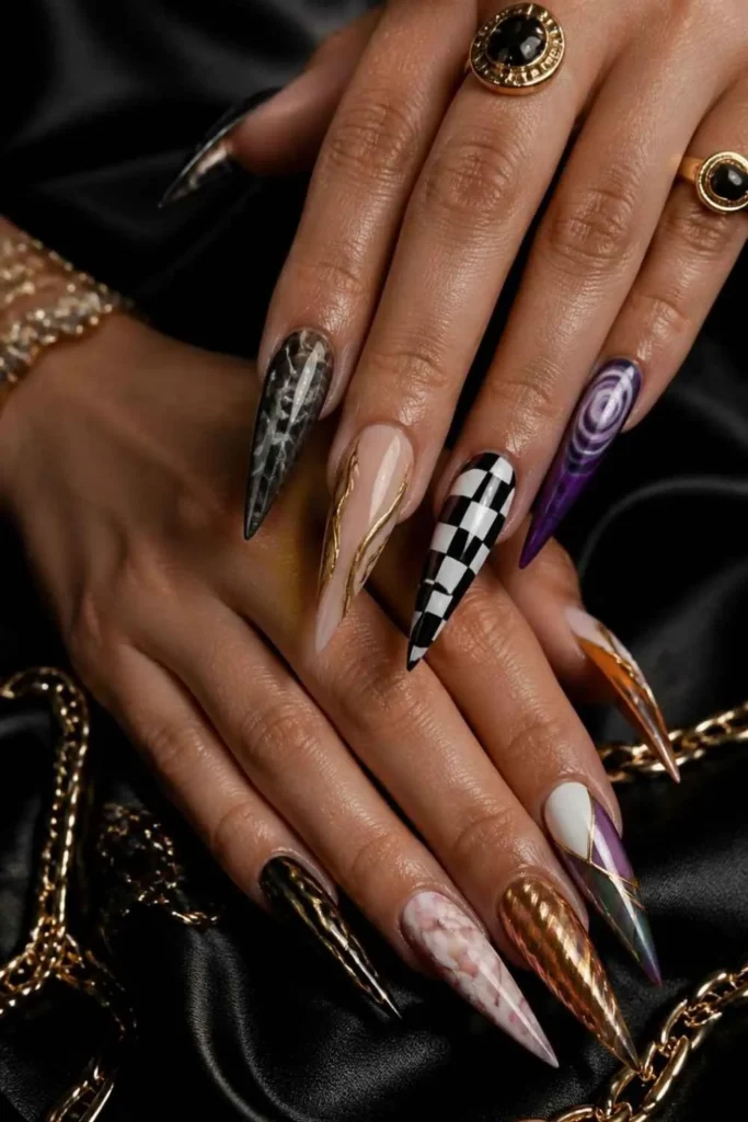 Long stiletto gel nails featuring mismatched abstract nail art, chrome, swirls, and geometric designs.