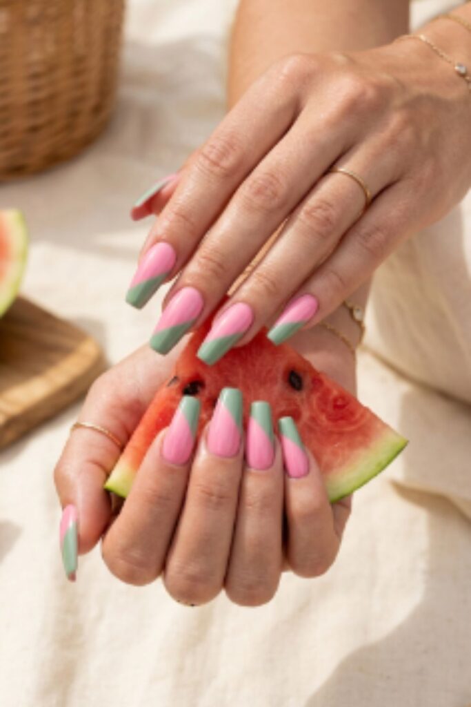 Bubble gum pink and sage green split-color nails inspired by watermelon with glossy coffin-shaped gel manicure.