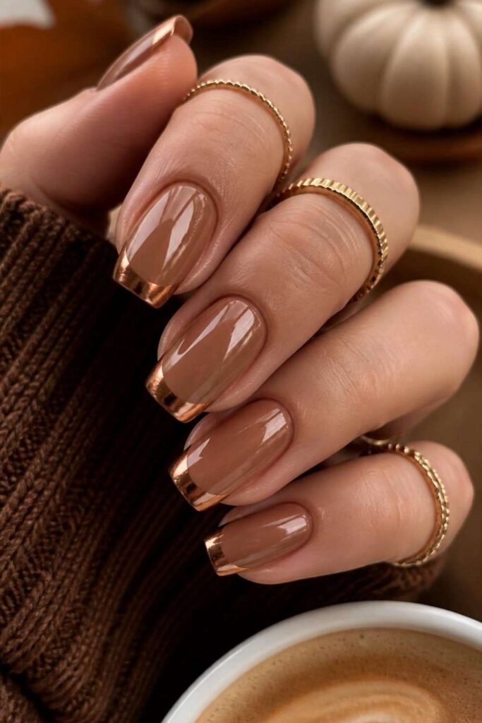Warm caramel square nails finished with metallic copper French tips for a luxurious seasonal manicure.